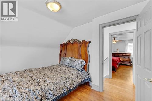 Finished attic room with sloped ceiling, wood-finish flooring, and a flush mount ceiling light - 1 Galbraith Drive, Hamilton, ON - Indoor Photo Showing Bedroom