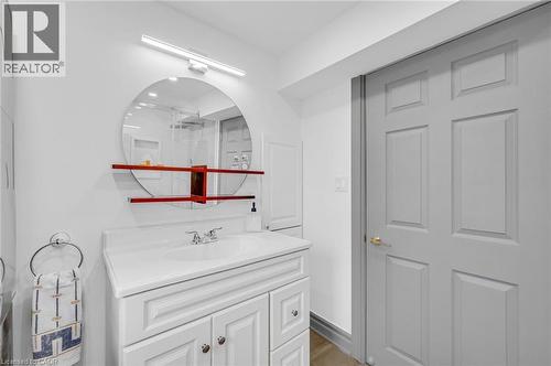 White vanity with panel-front cabinetry and a solid surface countertop - 1 Galbraith Drive, Hamilton, ON - Indoor Photo Showing Other Room
