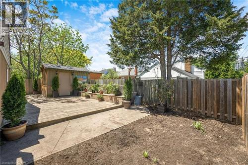 Spacious backyard featuring a wooden deck, concrete patio, and a dedicated garden shed - 1 Galbraith Drive, Hamilton, ON - Outdoor