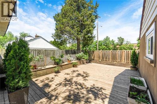 Expansive wood-finish deck with integrated planter boxes and a durable wood fence - 1 Galbraith Drive, Hamilton, ON - Outdoor With Deck Patio Veranda