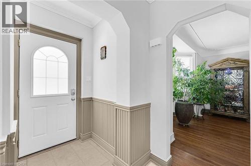 Entryway featuring a white door with an arched decorative glass insert, beadboard wainscoting, and crown molding - 1 Galbraith Drive, Hamilton, ON - Indoor Photo Showing Other Room