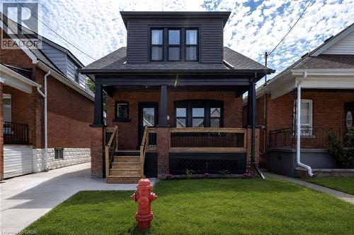 Brick exterior with dark trim and a prominent second-story dormer - 106 Grosvenor Avenue N, Hamilton, ON - Outdoor