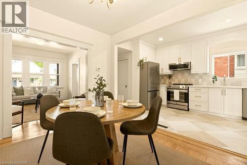 Open concept dining area featuring wood-finish flooring, recessed lighting, and a broad entryway to the living room - 106 Grosvenor Avenue N, Hamilton, ON - Indoor