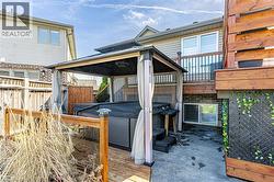 The property features a hot tub under a gazebo, situated on a wooden deck - 