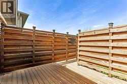 Outdoor deck featuring horizontal wood panel fencing with decorative post caps - 