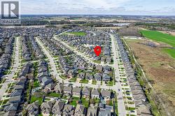 Aerial view of the property in a residential neighborhood, featuring established streets and houses with varied rooflines - 