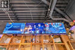 Industrial-style ceiling with exposed ductwork and structural beams - 