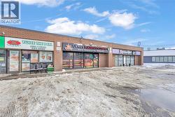 Commercial storefronts featuring brick exteriors, multiple display windows, and prominent signage - 