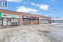 Commercial storefronts featuring brick exteriors, multiple display windows, and prominent signage - 402 King Street N, Waterloo, ON 