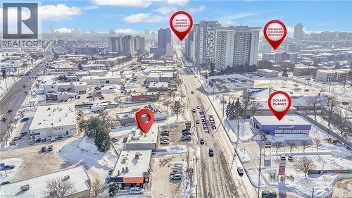 Aerial perspective showcasing King Street's commercial corridor with multiple businesses and high-rise residential buildings - 402 King Street N, Waterloo, ON 