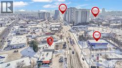 Aerial perspective showcasing King Street's commercial corridor with multiple businesses and high-rise residential buildings - 