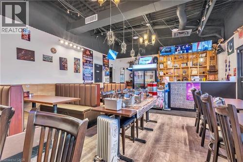 Spacious commercial interior featuring banquette seating and wood-finish flooring - 402 King Street N, Waterloo, ON 