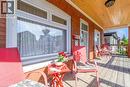 Inviting covered porch with a wood-finish ceiling, brick exterior, and wood-finish flooring - 121 Edgemont Street N, Hamilton, ON  - Outdoor With Deck Patio Veranda 