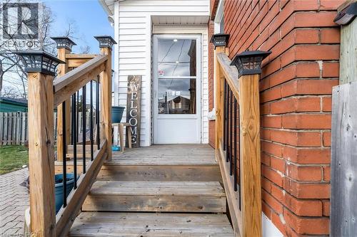 Hardwood deck with black metal spindle railings and solar-powered post cap lights - 121 Edgemont Street N, Hamilton, ON - Outdoor With Exterior