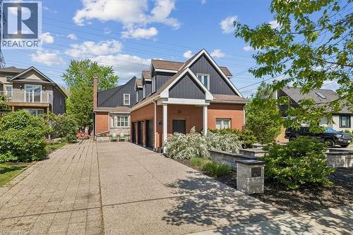 Brick and dark siding exterior with a multi-car driveway - 573 Beach Boulevard, Hamilton, ON - Outdoor