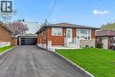 Brick and stone exterior with a prominent front entrance featuring white railings and steps - 74 Victor Boulevard, Hamilton, ON  - Outdoor 