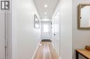 Bright entryway featuring wood-finish flooring, recessed ceiling lighting, a white panel door, and white baseboards - 185 Highland Crescent Unit# 2, Kitchener, ON  - Indoor Photo Showing Other Room 