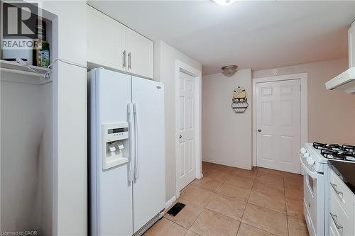 Kitchen featuring tile flooring and white appliances - 1 Vera Court, Hamilton, ON - Indoor