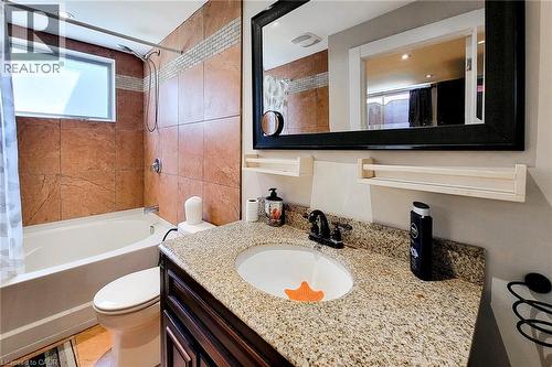Bathroom featuring a built-in tub and shower combination with full-height tile surround - 1 Vera Court, Hamilton, ON - Indoor Photo Showing Bathroom