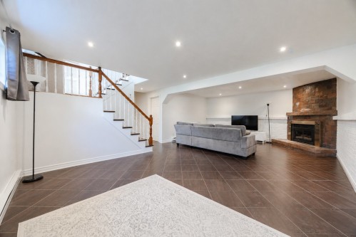 Basement - 14 Rue Dragon, Kirkland, QC - Indoor Photo Showing Other Room With Fireplace