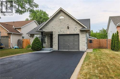 View of front of property with a garage, driveway, a gate, and brick siding - 4432 Dennis Avenue, Beamsville, ON - Outdoor