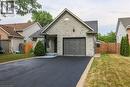 View of front of property with a garage, driveway, a gate, and brick siding - 4432 Dennis Avenue, Beamsville, ON  - Outdoor 