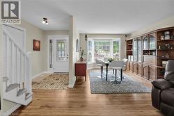 Entrance foyer with stairway and light wood-style floors - 