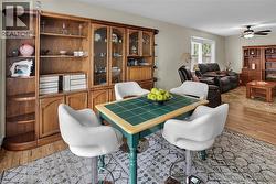 Dining area with light wood-style floors and a ceiling fan - 