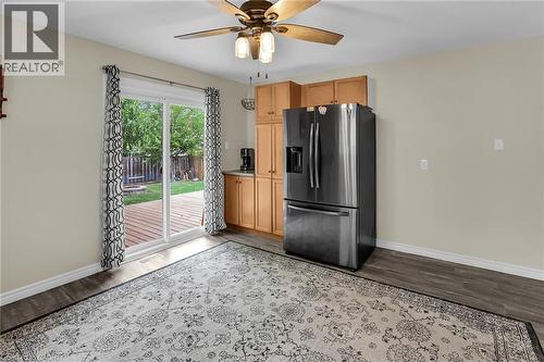 Kitchen with refrigerator with ice dispenser, wood finished floors, and a ceiling fan - 4432 Dennis Avenue, Beamsville, ON - Indoor