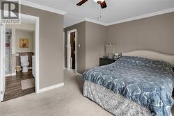 Primary Bedroom featuring ornamental molding, carpet flooring, and ceiling fan - 