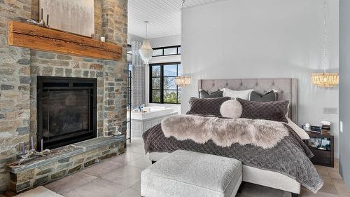 13210 Mccreight Road, Lake Country, BC - Indoor Photo Showing Bedroom With Fireplace