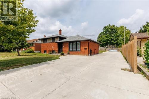 Brick exterior featuring black-framed windows and a dark shingled roof - 18 Silverdale Crescent, London, ON - Outdoor