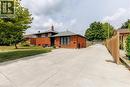 Brick exterior featuring black-framed windows and a dark shingled roof - 18 Silverdale Crescent, London, ON  - Outdoor 