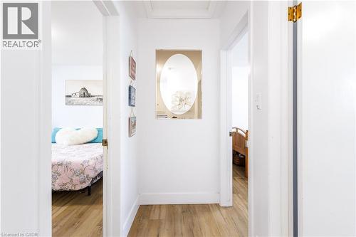 Hallway featuring wood-finish flooring and white baseboards - 18 Silverdale Crescent, London, ON - Indoor Photo Showing Other Room