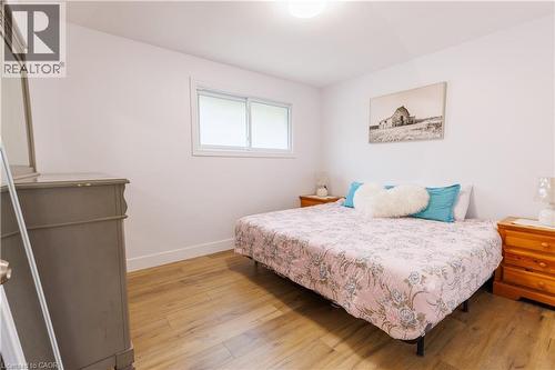 Bright room with wood-finish flooring, white walls, and a large window - 18 Silverdale Crescent, London, ON - Indoor Photo Showing Bedroom