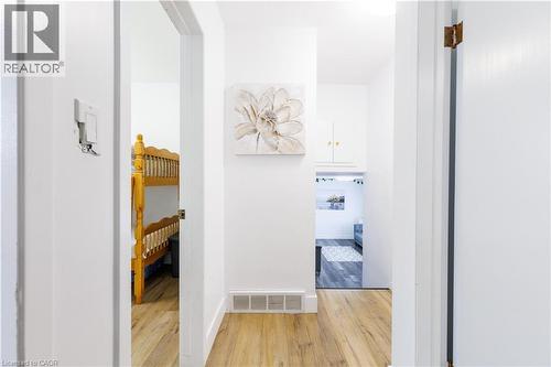 Hallway featuring wood-finish flooring, white walls, and built-in overhead cabinetry - 18 Silverdale Crescent, London, ON - Indoor Photo Showing Other Room