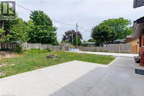 Expansive concrete patio with a grass lawn area - 18 Silverdale Crescent, London, ON - Outdoor