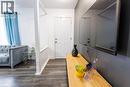 Entryway featuring wood-finish flooring, a white paneled door, and white baseboards - 18 Silverdale Crescent, London, ON  - Indoor Photo Showing Other Room 