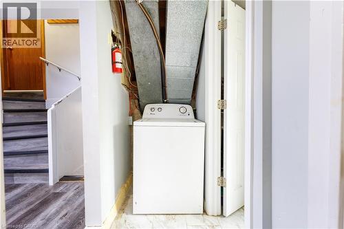 Appliance area featuring a white washing machine, exposed ductwork, and light-colored walls - 18 Silverdale Crescent, London, ON - Indoor Photo Showing Laundry Room