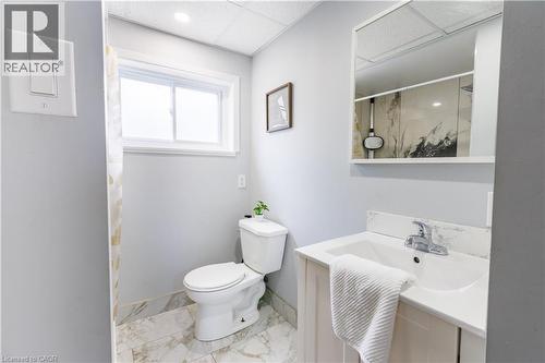 Bathroom featuring a single window, recessed lighting, and a white vanity with an integrated sink - 18 Silverdale Crescent, London, ON - Indoor Photo Showing Bathroom