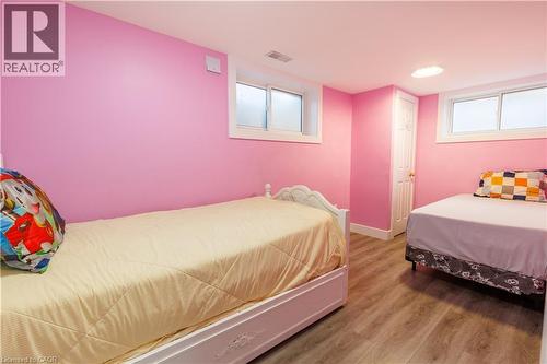 Room featuring pink walls and wood-finish flooring - 18 Silverdale Crescent, London, ON - Indoor Photo Showing Bedroom