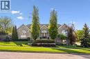 Brick facade residence featuring arched windows, mature landscaping, and an inviting front entrance with a dark door - 20 Bonniewood Drive, Drayton, ON  - Outdoor 