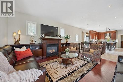 Living area with hardwood flooring and an integrated fireplace - 20 Bonniewood Drive, Drayton, ON - Indoor Photo Showing Living Room With Fireplace