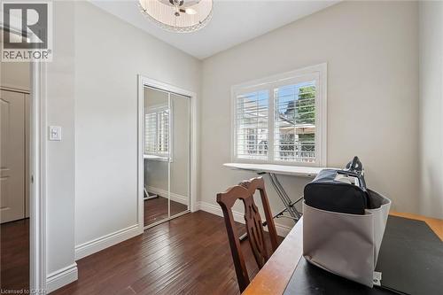 Room featuring wood-finish flooring, a window with louvered shutters, mirrored closet doors, and crown molding - 20 Bonniewood Drive, Drayton, ON - Indoor Photo Showing Office