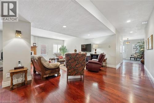 Spacious living area featuring rich wood-finish flooring, recessed lighting, and light-toned wall finishes - 20 Bonniewood Drive, Drayton, ON - Indoor Photo Showing Living Room