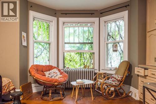 Bay window with multiple sash windows, white trim, and a radiator below - 95-97 S Fairholt Road S, Hamilton, ON - Indoor