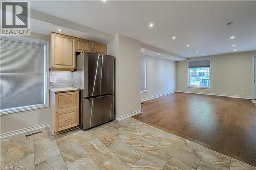 Kitchen area featuring stainless steel refrigerator, tile backsplash, wood-finish cabinetry, and recessed lighting - 319 King Street W, Dundas, ON - Indoor Photo Showing Kitchen With Stainless Steel Kitchen