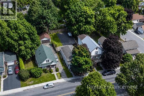 Aerial perspective showcasing a residential property with a green-shingled roof, a front porch, and a dedicated driveway - 319 King Street W, Dundas, ON - Outdoor