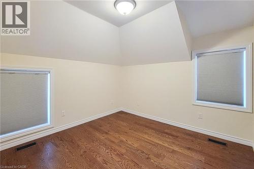 Room featuring wood-finish flooring, two windows with blinds, and white trim - 319 King Street W, Dundas, ON - Indoor Photo Showing Other Room