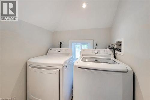 Dedicated laundry area with a white top-load washing machine and a white front-load dryer - 319 King Street W, Dundas, ON - Indoor Photo Showing Laundry Room